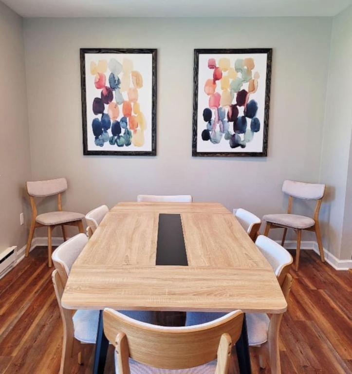 a conference room with a wooden table and chairs at Just Beachy Sleeps 10 in Wildwood Highlands Beach