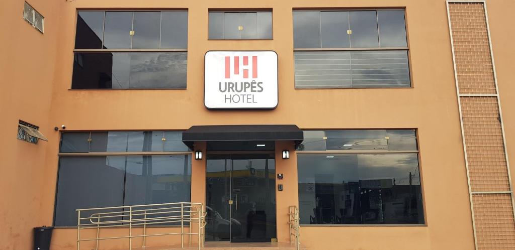 a building with a sign for a hotel at Urupês Hotel in Urupês