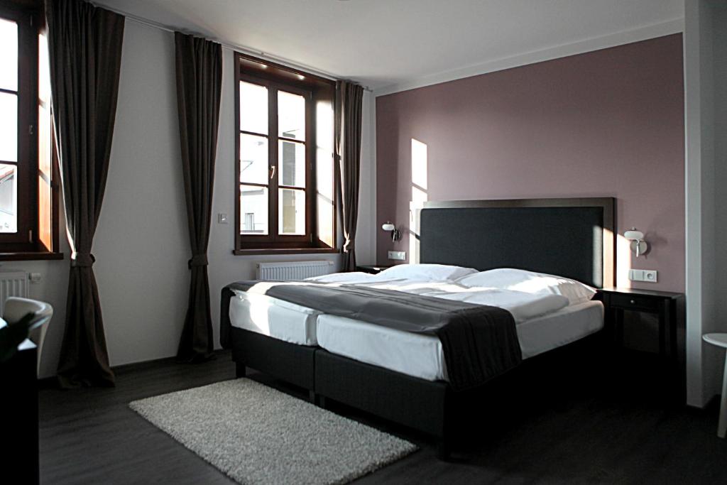 Postel nebo postele na pokoji v ubytování Hotel Koruna