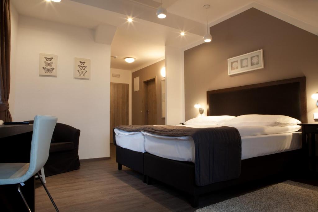 Postel nebo postele na pokoji v ubytování Hotel Koruna