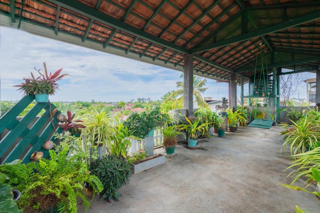 a patio with potted plants in a building at The garden gate resort & Apartments No 02 in Negombo