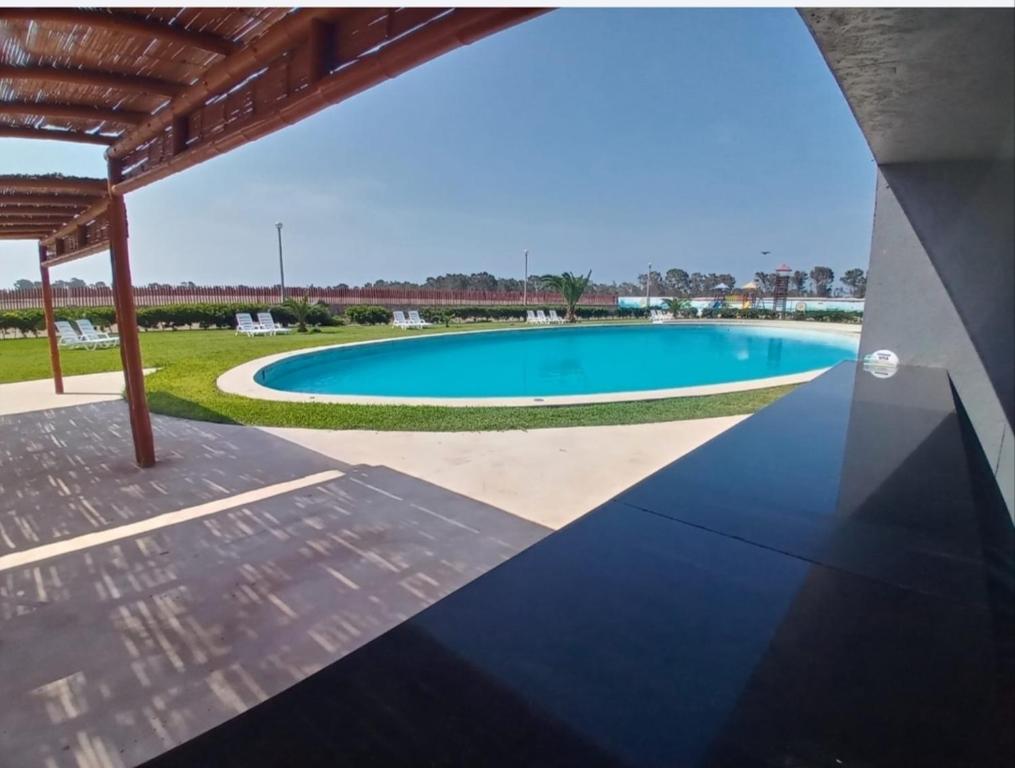 a view of a swimming pool from the patio of a house at Duplex con piscina en Asia in Asia