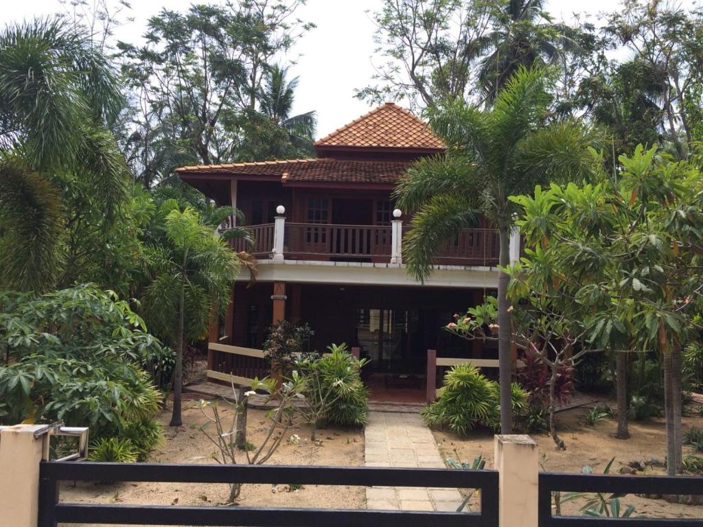 a house with a balcony in the middle of trees at Thai House by Dow Residence in Lamai