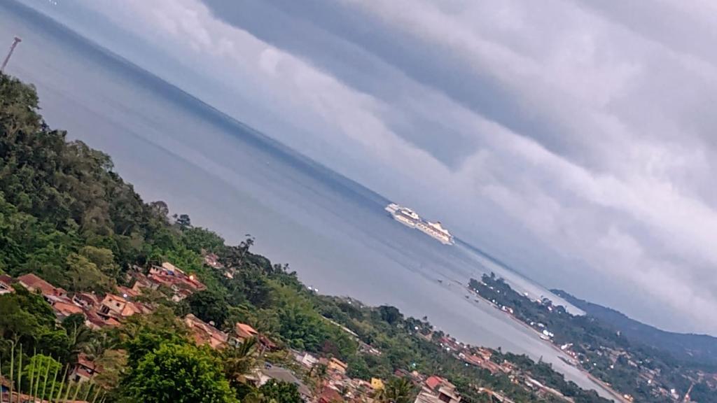 un barco en el agua de un río en Casa temporada, en Ilhabela