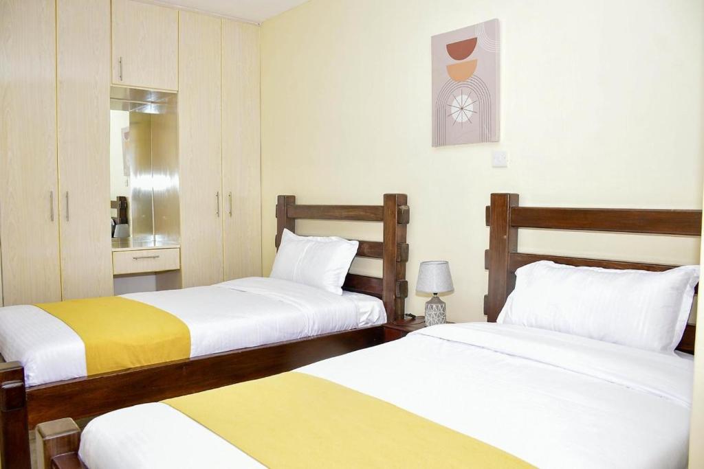 a hotel room with two beds and a room with at Elegant 2 bedroom fully furnished at 360 in Kitale
