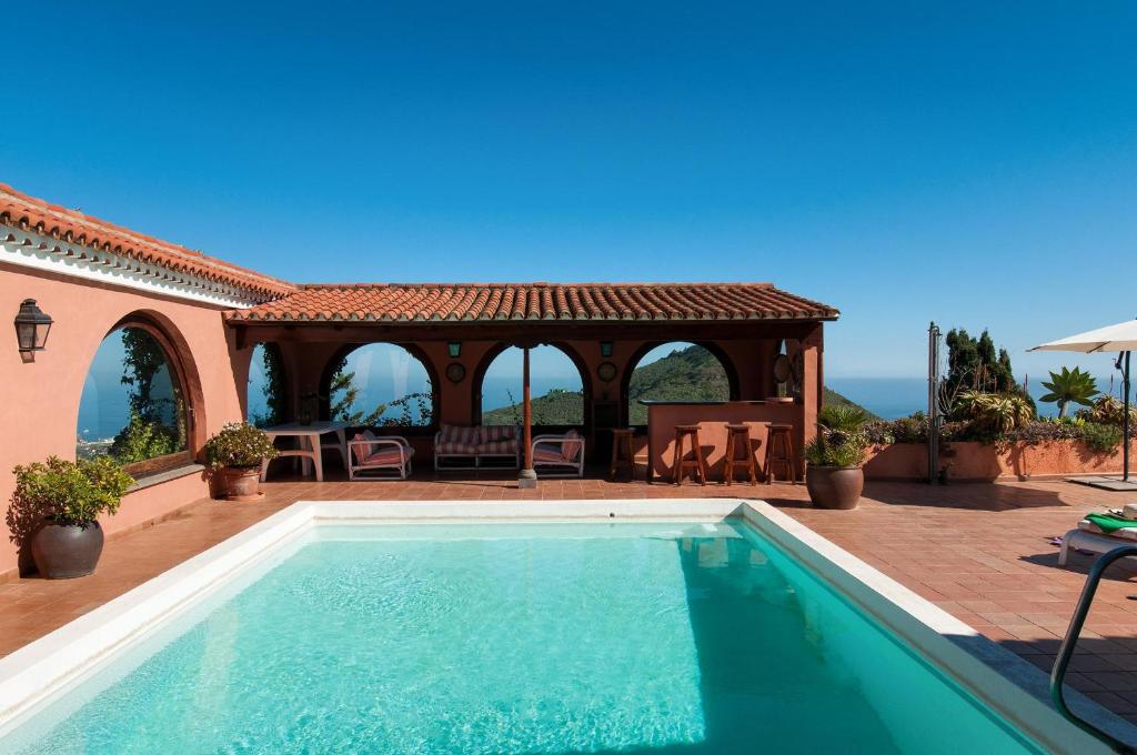 a swimming pool in front of a house with a gazebo at Mansion Bandama by VillaGranCanaria in Tafira