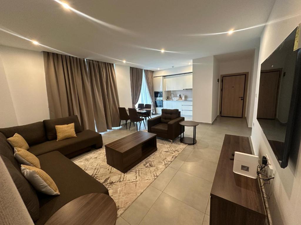 a living room with a couch and a table at Luxury Nova Roman Ridge 2-bedroom apartment in Accra - FiveHills homes in Accra