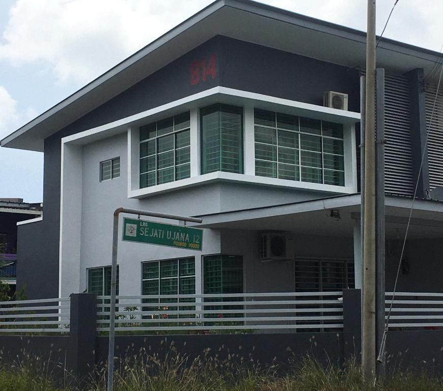 a white building with a sign in front of it at Sandakan Js homestay in Sandakan