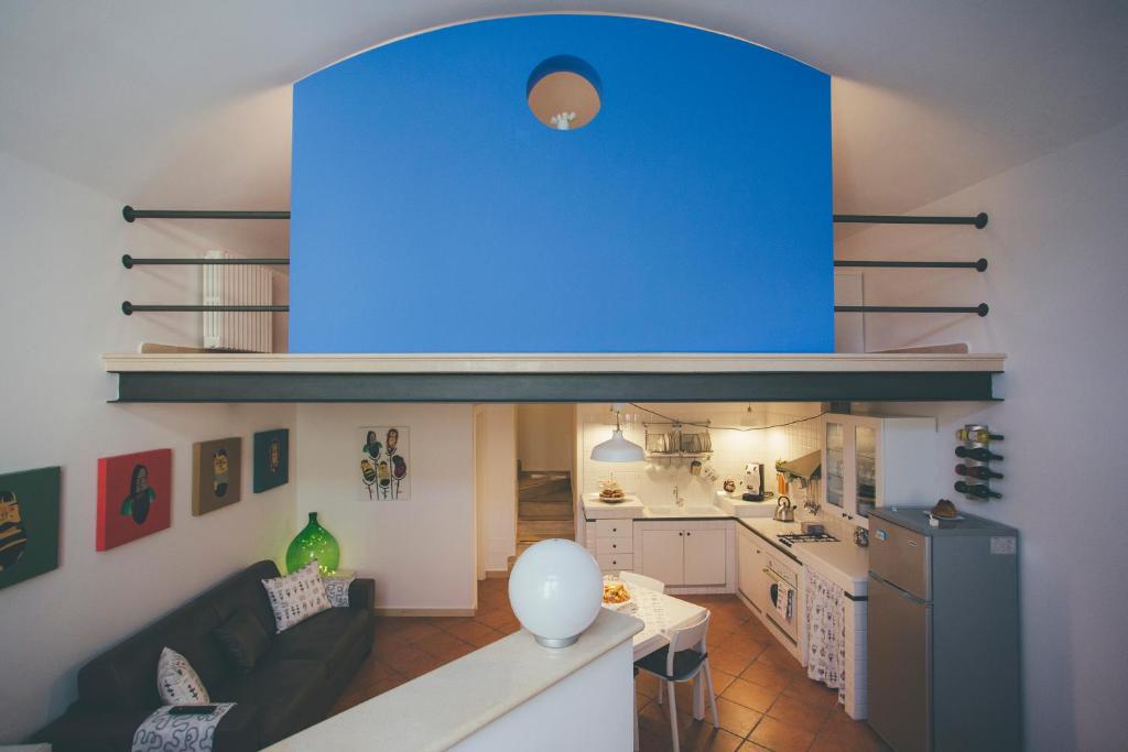a living room and a kitchen with a blue ceiling at I Sassi Di Teopista in Matera