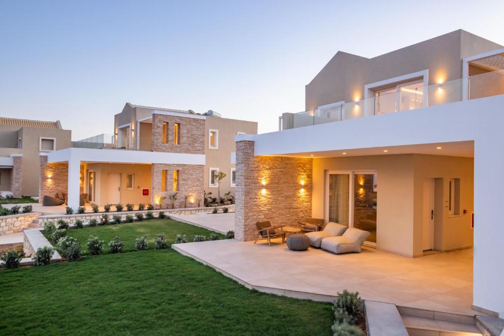 a large house with a lawn in front of it at Thalassa Suites in Afiartis