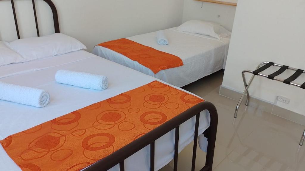 En eller flere senge i et værelse på Casa Carolina