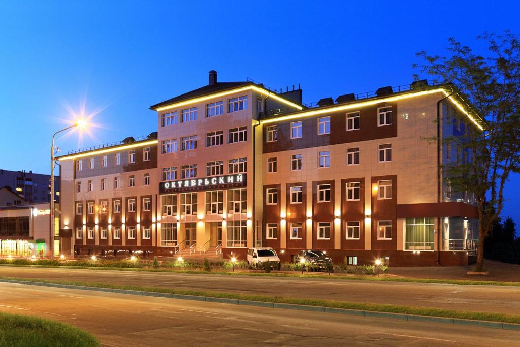 a large building on the side of a street at night at Complex Oktyabrskiy in Stavropol