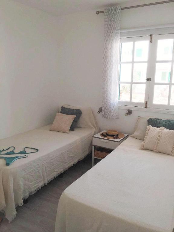 A bed or beds in a room at Calma apartment On the most amazing beach in Fuerteventura