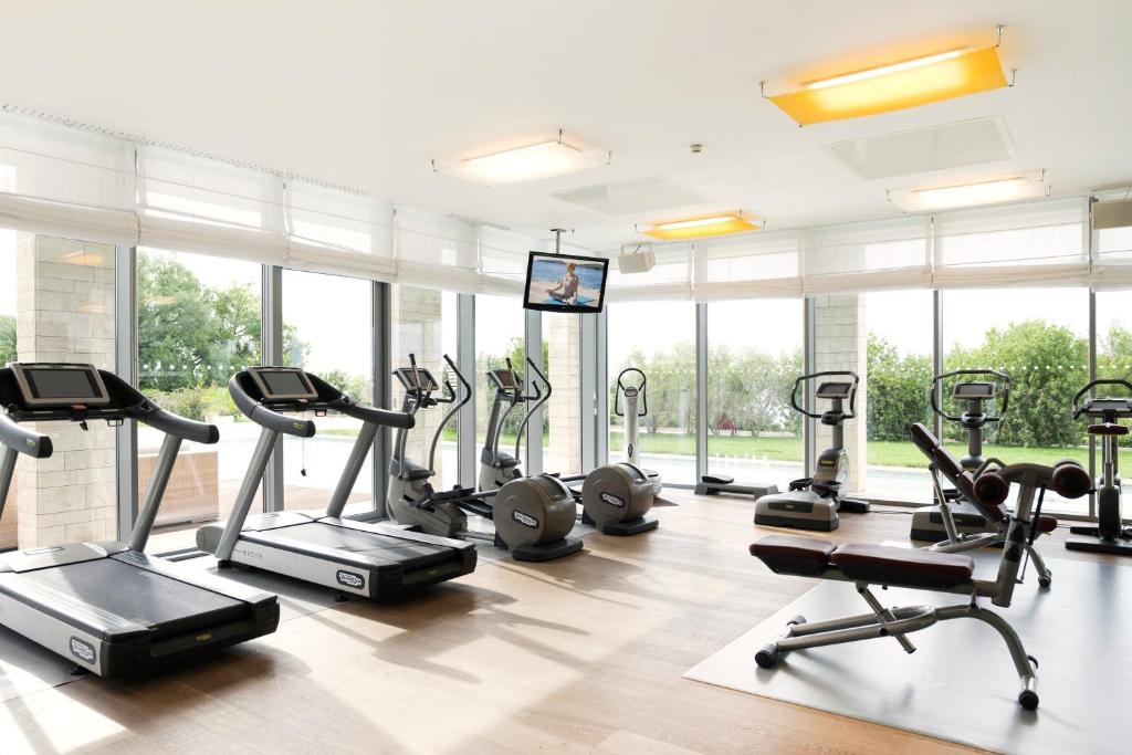 a gym with treadmills and elliptical machines at Sun Gardens Dubrovnik in Dubrovnik