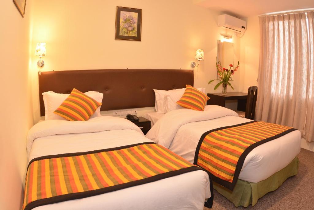 Postel nebo postele na pokoji v ubytování Hotel Serenity