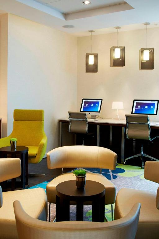a waiting room with two computers on a desk at Courtyard by Marriott Aberdeen Airport in Dyce