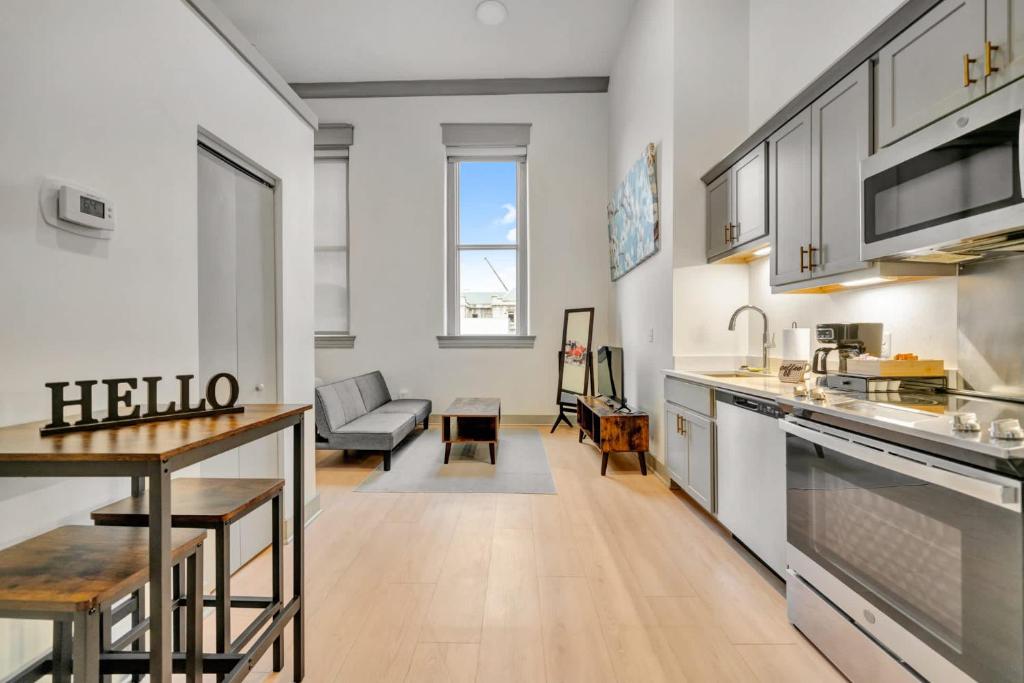 a kitchen and living room with a couch and a table at Bright and Modern Studio in Louisville # 304 in Louisville