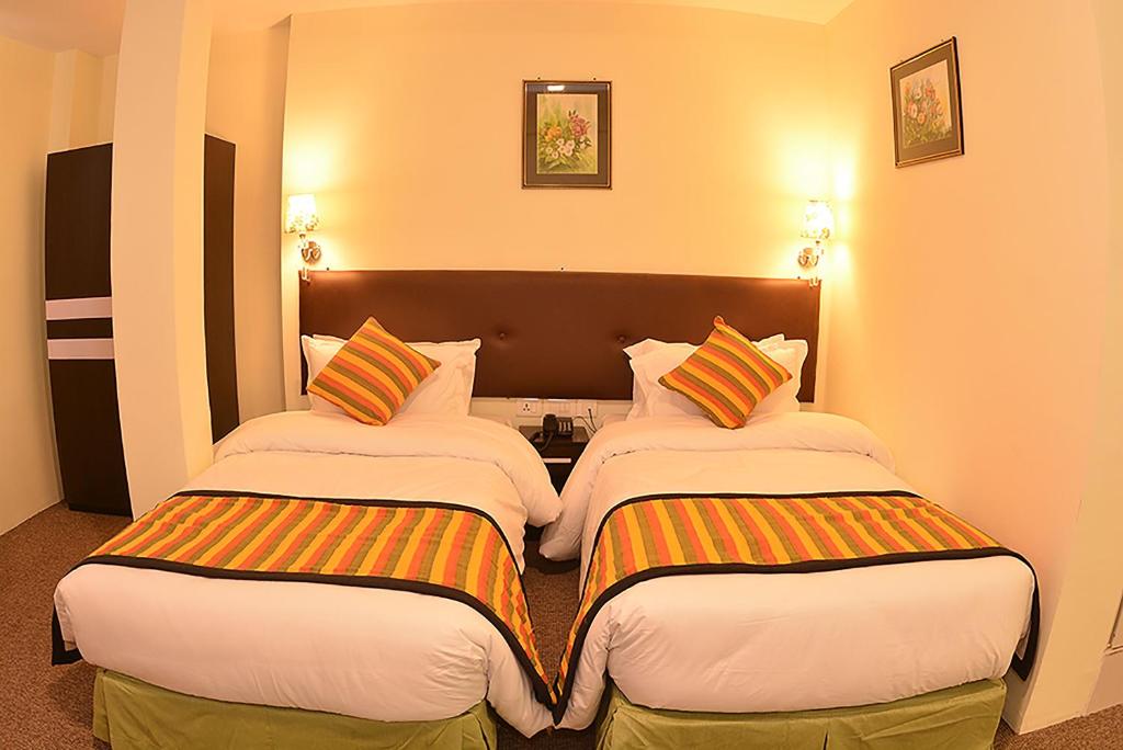 Postel nebo postele na pokoji v ubytování Hotel Serenity