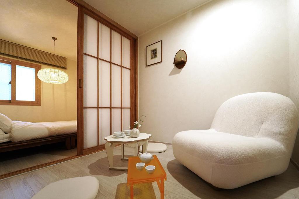 a living room with a white chair and a table at Naseonjae-Namsan Tower in Seoul