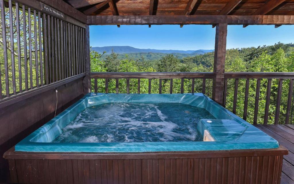 a hot tub on the deck of a cabin at Peak A View in Sevierville
