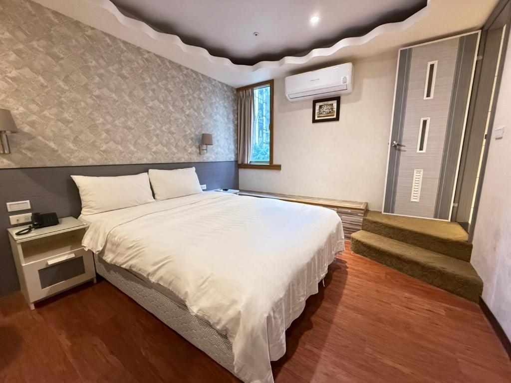 Postel nebo postele na pokoji v ubytování 漫旅時光旅店