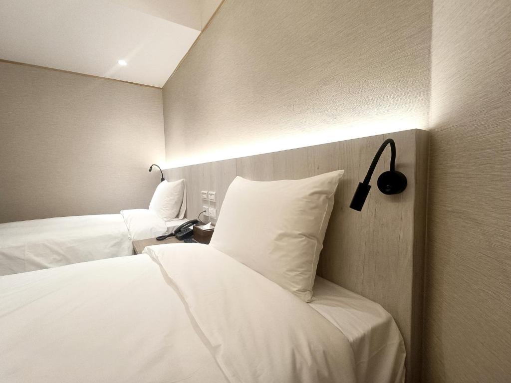 Postel nebo postele na pokoji v ubytování 衿后禾居Good Hotel