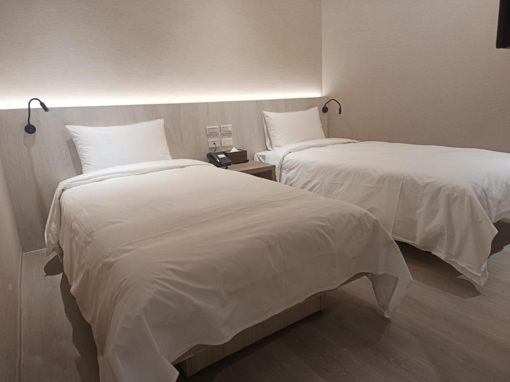 Postel nebo postele na pokoji v ubytování 衿后禾居Good Hotel