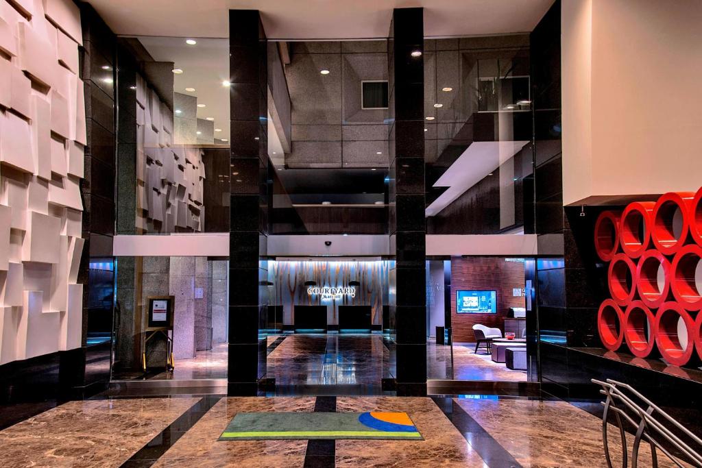 a lobby of a building with a rug on the floor at Courtyard by Marriott Mexico City Revolucion in Mexico City