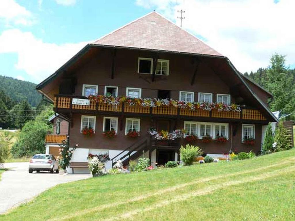 a large house with flowers in front of it at Gästehaus Klingele in Todtmoos