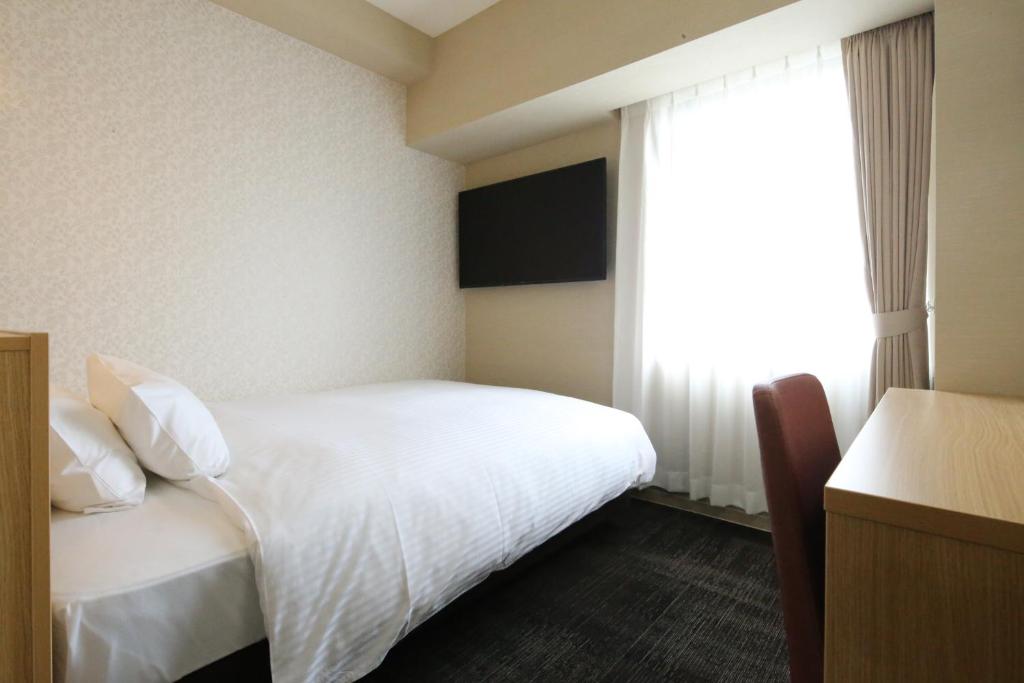 Postel nebo postele na pokoji v ubytování AB Hotel Hikone