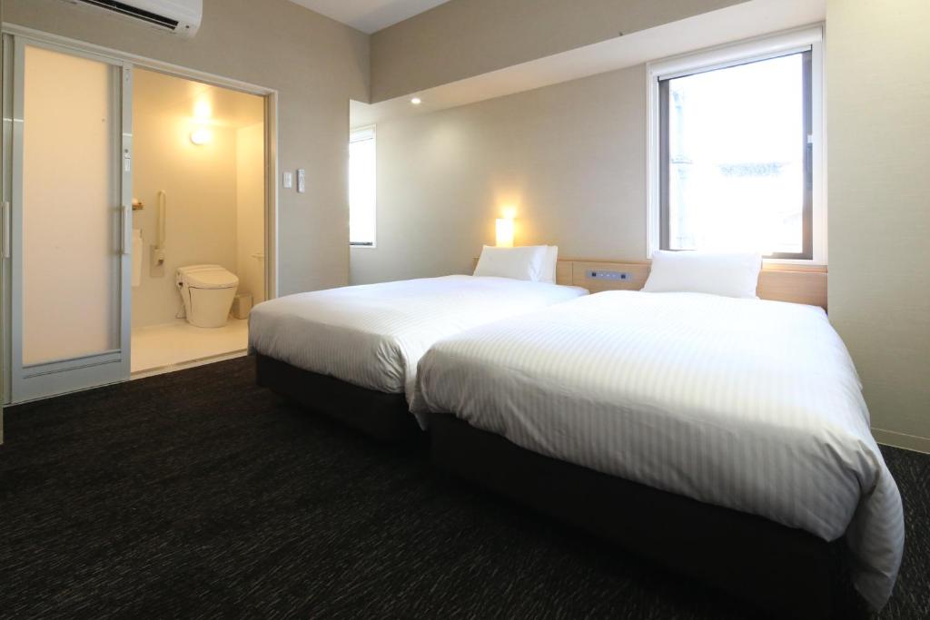 Postel nebo postele na pokoji v ubytování AB Hotel Hikone
