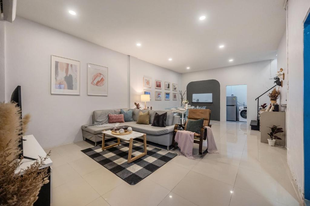 a living room with a couch and a table at Spacious Haven Chatuchak Market 5BR 10 Sleeps RB1 in Ban Zong Katiam