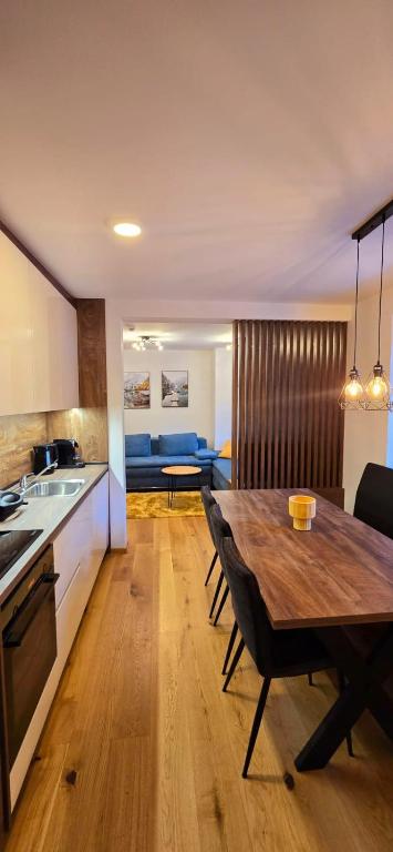 a kitchen and dining room with a wooden table at Poku bajka in Kranjska Gora
