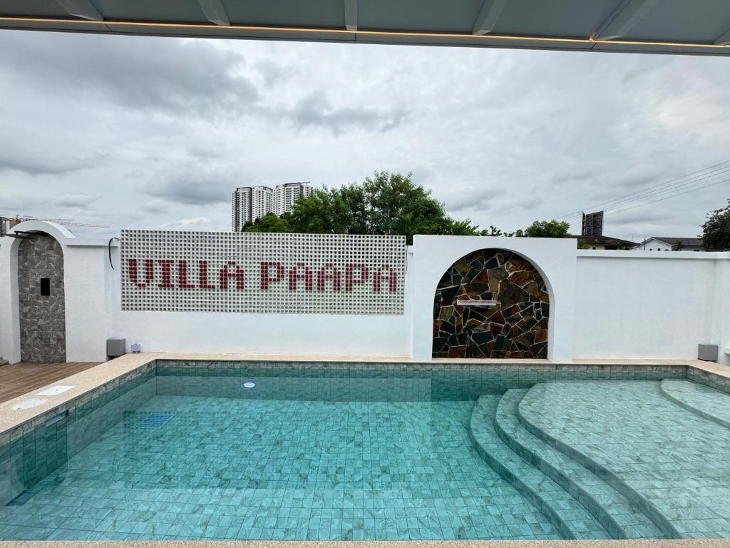 a swimming pool in front of a building at Villa Paapa & Maama in Johor Bahru