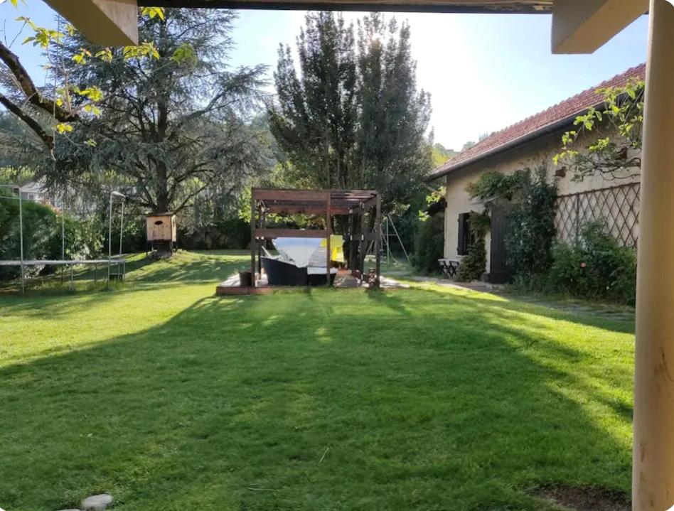 a large yard with a playground in a house at Maison chalet au calme avec jardin in Aix-les-Bains