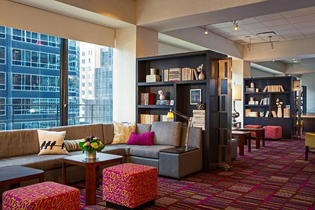a lobby with couches and tables and a large window at Courtyard New York Manhattan/Midtown East in New York