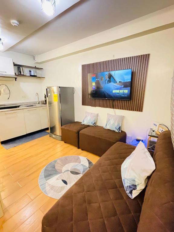 a living room with a couch and a flat screen tv at Gin Studio Rent Davao in Davao City