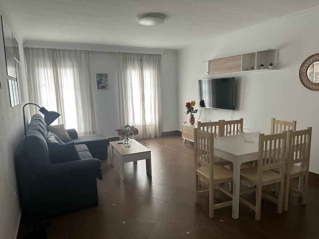 a living room with a table and a dining room at El pasaje Apart in Ronda