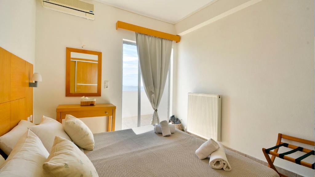 Postel nebo postele na pokoji v ubytování Sunrise Beach Ipsos