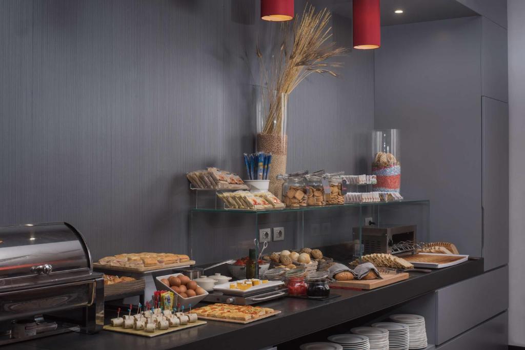 a buffet line with various pastries and other foods at NH Trieste in Trieste