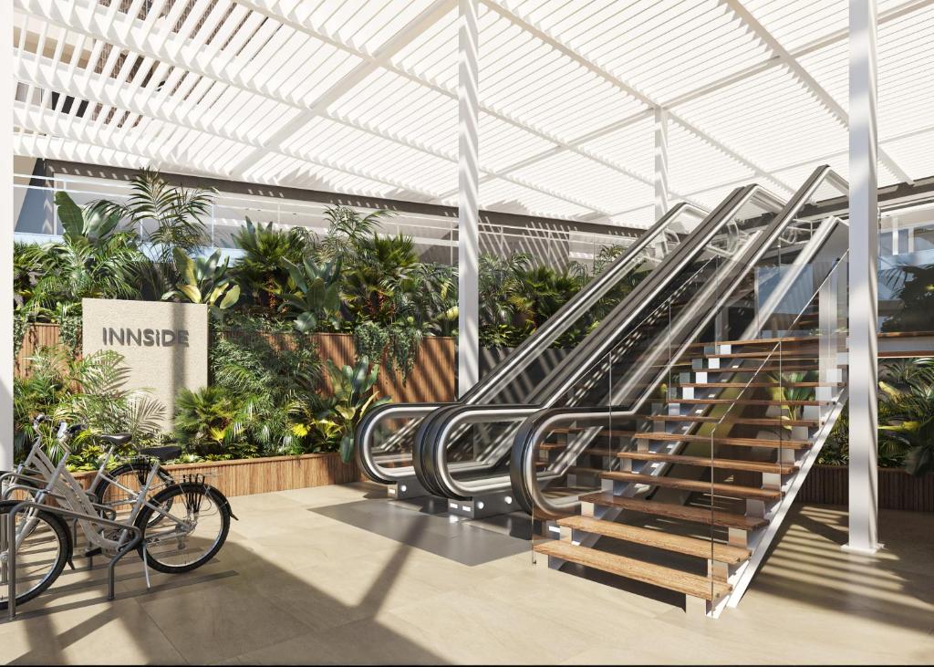 a staircase in a building with a bunch of plants at INNSiDE by Meliá Alicante Porta Maris in Alicante