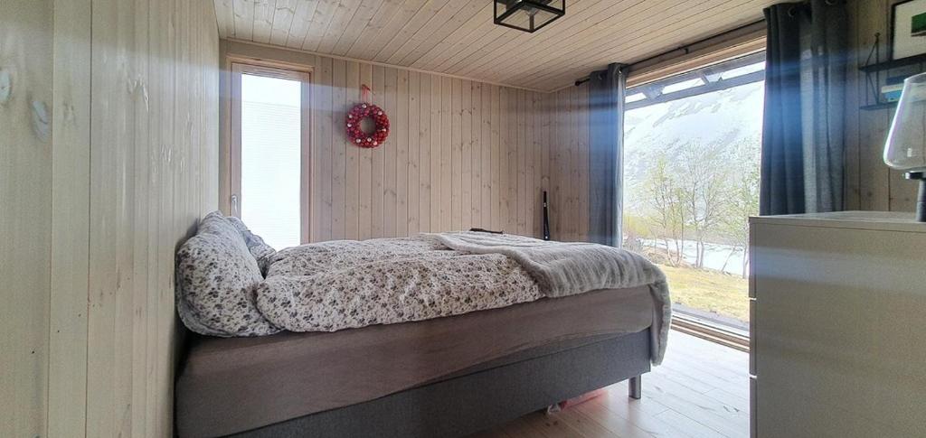 a bedroom with a bed in a room with a window at Cozy Family Cabin In Uniquely Situated Hiking Area in Indre Standal