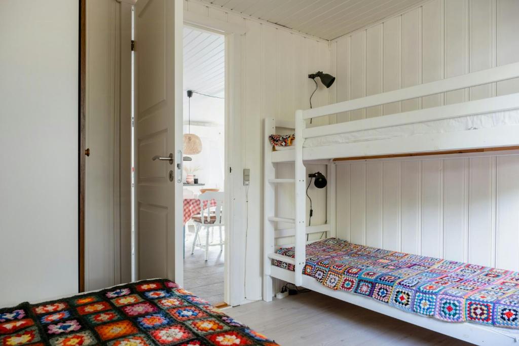 a bedroom with two bunk beds and a doorway at Magical Atmosphere Close To The Sea in Sæby