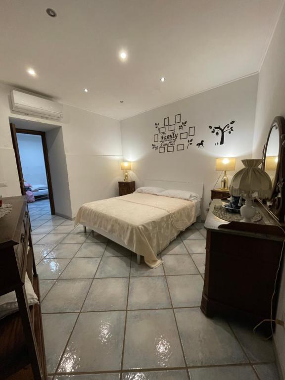 a bedroom with a bed and a table and a mirror at StabiaSummer in Castellammare di Stabia