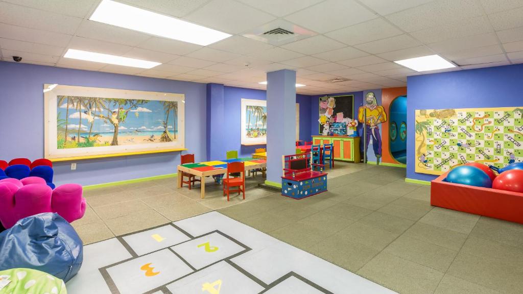 a room with a classroom with colorful walls and desks at Bougainvillea Barbados in Christ Church