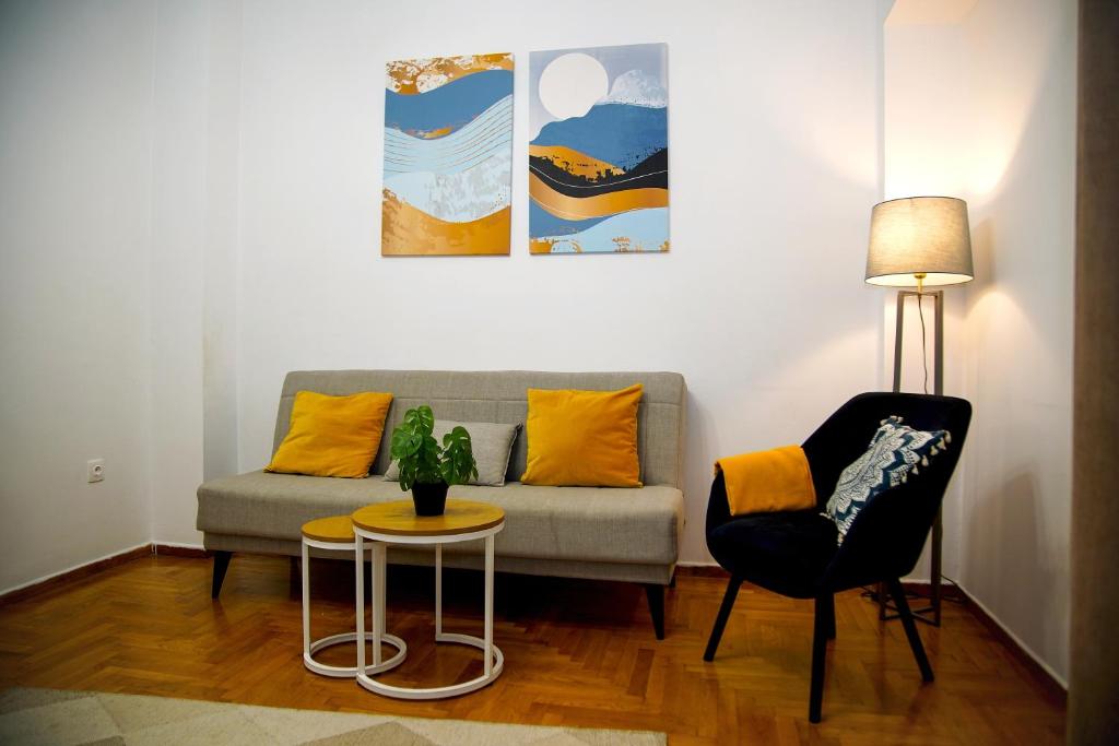 a living room with a couch and a table and a chair at Superb New Family Apartment VIPGreece in Athens