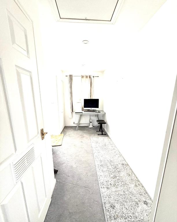 an empty hallway with a door and a desk at Rose home in Haverhill