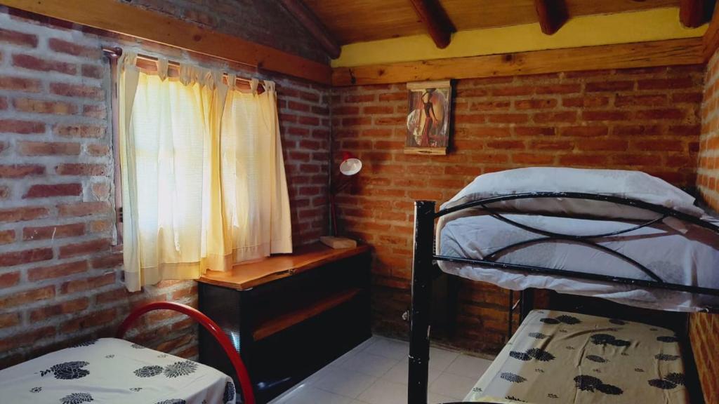 En eller flere senge i et værelse på Bosque Nativo