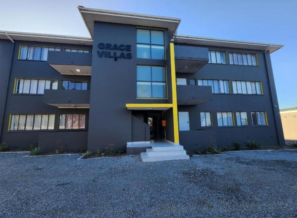 a building with a sign on the front of it at Grace Villas 25 in East London