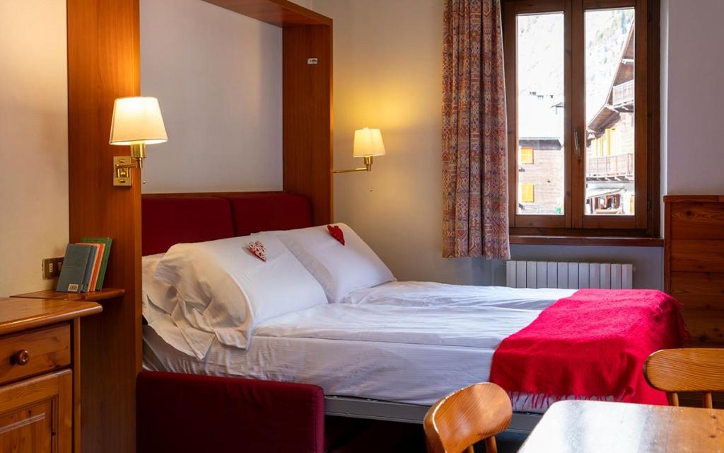 Postel nebo postele na pokoji v ubytování Residence Monterosa